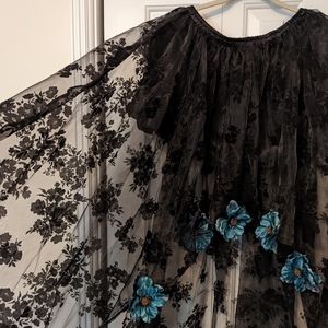 Ladies high low skirt The skirt has black laced imprint with hand sewn flowers.